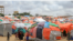 Somali children who fled drought-stricken areas stand by their makeshift shelters in the outskirts of Mogadishu, Sept. 3, 2022. AP