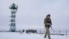 A Ukrainian border guard patrols the border with Russia not far from Hoptivka village, Kharkiv region, Ukraine, Feb. 2, 2022.