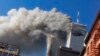 FILE - Smoke rises from the burning twin towers of the World Trade Center after hijacked planes crashed into them, in New York City, Sept. 11, 2001