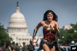 This image released by Warner Bros. Pictures shows Gal Gadot as Wonder Woman in a scene from "Wonder Woman 1984." (Clay Enos/Warner Bros Pictures via AP)