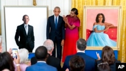 Former President Barack Obama and former first lady Michelle Obama unveil their official White House portraits during a ceremony in the East Room of the White House, Sept. 7, 2022, in Washington.