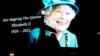 FILE - People pass by an image of Queen Elizabeth II projected onto a large screen at Piccadilly Circus, in London, Sept. 8, 2022. 