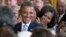 FILE - President Barack Obama and first lady Michelle Obama applaud during the portrait unveiling ceremony for former President George W. Bush and former first lady Laura Bush portraits, May 31, 2012, at the White House in Washington. 