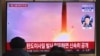 FILE - People watch a television screen broadcasting file footage of a North Korean missile test at a railway station in Seoul, South Korea, on Jan. 30, 2022.