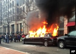 Protesters set a parked limousine on fire in downtown Washington during the inauguration of President Donald Trump, Jan. 20, 2017. Protesters registered their rage against the new president in a chaotic confrontation with police who used pepper spray and stun grenades in a melee just blocks from the inaugural parade route. Nearly 100 people were arrested.
