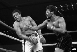 In this 1978, file photo, Leon Spinks, right, throws a punch at Muhammad Ali during their championship fight in Las Vegas. (AP Photo/File)