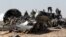 Military investigators from Russia stand near the debris of a Russian airliner at the site of its crash at the Hassana area in Arish city, north Egypt, Nov. 1, 2015. 