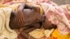 FILE - A severely malnourished child lies in bed at a Doctors Without Borders hospital Bentiu, South Sudan, July 3, 2014.