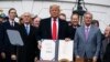 President Donald Trump shows off a new North American trade agreement with Canada and Mexico, during an event at the White House, Jan. 29, 2020, in Washington. 