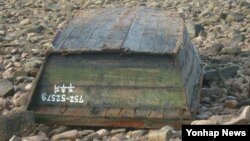 북한 어선으로 추정되는 폐목선이 22일 충남 서산 대산지역 바닷가에 떠밀려와 있다.
