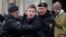 FILE - Police detain journalist Raman Pratasevich in Minsk, Belarus, March 26, 2017. Pratasevich, a founder of a messaging channel popular with the country's opposition, has been arrested after a plane in which he was a passenger was diverted to Minsk.