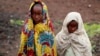 Girls, displaced by recent fighting between Congolese army and the M23 rebels, cover themselves from the cold in Munigi village near Goma in the eastern Democratic Republic of Congo September 1, 2013.