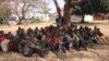Illegal Ethiopian immigrants await trial outside the Karonga Court, Malawi, Sept. 24, 2014. (Tiwonge Kumwenda/VOA)