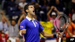 Novak Djokovic, of Serbia, reacts after breaking Roger Federer's serve to win a game in the fourth set during the men's championship match of the U.S. Open tennis tournament, Sunday, Sept. 13, 2015.