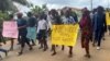 Schoolchildren, their parents and teachers hold a protest after gunmen opened fire at a school in Kumba, Cameroon, Oct. 25, 2020. At a protest in Yaounde, Cameroon, Tuesday, teachers called for better protection against violence and attacks.