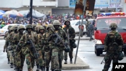 FILE - Liberian army soldiers walk on the Monrovia bridge during a training exercise in Monrovia, June 24, 2016.