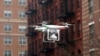 FILE - A drone flies near the scene where two buildings were destroyed in an explosion, in the East Harlem section in New York City, March 12, 2014.