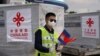 FILE - An airport worker is seen as a Chinese plane arrives with medical workers and supplies donated from China to Cambodia to contain the coronavirus disease (COVID-19) outbreak, at Phnom Penh International Airport in Cambodia, March 23, 2020. REUTERS/Cindy Liu