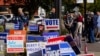 FILE - Voters wait in line to cast their ballots on the second day of early voting in in Noblesville, Indiana, Oct. 7, 2020.