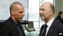 Greek Finance Minister Yanis Varoufakis, left, and Commissioner for Economic and Financial Affairs, Taxation and Customs, Pierre Moscovici at the Informal Meeting of Ministers for Economic and Financial Affairs of the EU in Riga, Apr. 24, 2015.