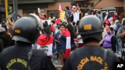 People celebrate in the street after Peru's new interim President Francisco Sagasti was designated by Congress to lead the nation, in Lima, Peru, Nov. 16, 2020. 