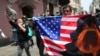 FILE - Protesters against Peruvian President Martin Vizcarra, who faces an impeachment vote, carry a U.S. flag with the letter Q, referring to QAnon, near Congress in Lima, Peru, Nov. 9, 2020. 
