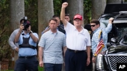 FILE - U.S. President Donald Trump gestures to supporters as he leaves the Trump International Golf Club on Feb. 17, 2025, in West Palm Beach, Florida. As Trump prepares for his annual physical exam, his main source of exercise is golf.
