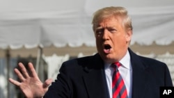 President Donald Trump talks to the media before leaving the White House, Nov. 9, 2019, in Washington. 