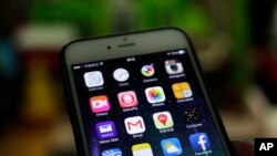 A Gmail mobile app, center left, seen on a smartphone in Beijing, Dec. 29, 2014. 