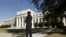 FILE - A Federal Reserve police officer keeps watch while posted outside the Federal Reserve headquarters in Washington, Sept. 16, 2015.