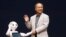 SoftBank Corp. Chief Executive Masayoshi Son (R) waves with the company's human-like robots named 'pepper' during a news conference in Urayasu, east of Tokyo June 5, 2014. 