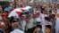 Jordanian soldiers and relatives of Belal Al-Zuhbe, one of the solders killed in an attack on a border military post near a camp for Syrian refugees, carry his body during his funeral at Nahleh village in the city of Jerash, north of Amman, Jordan, June 2