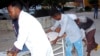 Medical workers help a person on a stretcher who was wounded in a suicide bombing at Madina hospital, Mogadishu, July 24, 2019. 