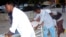 Medical workers help a person on a stretcher who was wounded in a suicide bombing at Madina hospital, Mogadishu, July 24, 2019. 