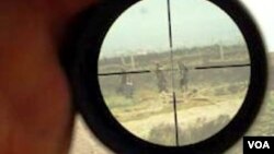 Workers carry a rope to a decommissioned ship at the Alang shipyard in the western Indian state of Gujarat.