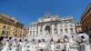 Brides wearing wedding dresses hold a flash mob near Trevi fountain to protest against the postponement of their weddings due to the coronavirus disease (COVID-19) outbreak in Rome, Italy, July 7, 2020. 