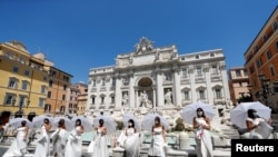 Brides wearing wedding dresses hold a flash mob near Trevi fountain to protest against the postponement of their weddings due to the coronavirus disease (COVID-19) outbreak in Rome, Italy, July 7, 2020. 