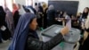 An Afghan woman casts her vote during parliamentary elections at a polling station in Kabul, Afghanistan, Oct. 20, 2018. 