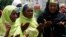 Muslim women pray at a meeting calling on the government to rescue the kidnapped girls of the government secondary school in Chibok, in Abuja, Nigeria, May 27, 2014. 