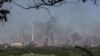 Smoke rises after a military strike on a compound of Sievierodonetsk's Azot Chemical Plant, amid Russia's attack on Ukraine, in the town of Lysychansk, Luhansk region, Ukraine, June 10, 2022. 