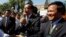 Opposition leader of Cambodia National Rescue Party Sam Rainsy, center, delivers a speech next to his Deputy President Kem Sokha, right, during a gathering to mark Human Rights Day, in front of National Assembly, in Phnom Penh, Cambodia, Wednesday, Dec. 10, 2014. (AP Photo/Heng Sinith