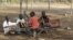 FILE - Children play with a broken playground chair in Kakuma refugee camp in northwestern Kenya. 