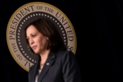 U.S. Vice President Kamala Harris stands by as President Joe Biden delivers remarks in the Eisenhower Executive Office Building's South Court Auditorium at the White House in Washington, June 2, 2021.