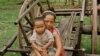 A mother and child of the Phnong tribal group rest after scouring for food in Kampong Pneu, a remote, poor region of northeastern Cambodia.