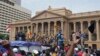 Protesters, many carrying Sri Lankan flags, gather outside the presidents office in Colombo, Sri Lanka, July 9, 2022. Sri Lankan protesters stormed President Gotabaya Rajapaksa's residence and nearby office on Saturday as tens of thousands of people took 