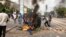 Protesters throw a dumpster on a fire in Dakar, Senegal, June 17, 2022. (Annika Hammerschlag/VOA)