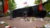 A man leaves flowers at a memorial site after a mass shooting at a Fourth of July parade in the Chicago suburb of Highland Park, Illinois, July 6, 2022.
