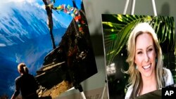 FILE - In this July 23, 2018, photo, posters of Justine Ruszczyk Damond are displayed at a news conference by attorneys for her family in Minneapolis.