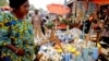 FILE - A woman shops at the Mvog Ada market in Yaounde, Cameroon, Jan. 29, 2022. President Paul Biya has for the first time sent a delegation to Europe to try to encourage well-off Cameroonians living there to invest back home.