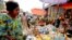 FILE - A woman shops at the Mvog Ada market in Yaounde, Cameroon, Jan. 29, 2022. 